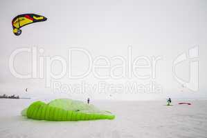 Kiteboarder with kite on the snow