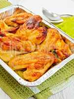 Chicken wings fried in pan from foil