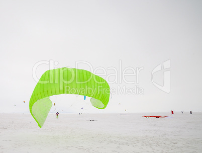 Kiteboarder with kite on the snow