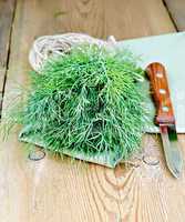 Dill green with knife and napkin on board