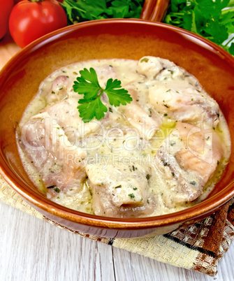 Fish stew in sauce on ceramic pan with tomatoes