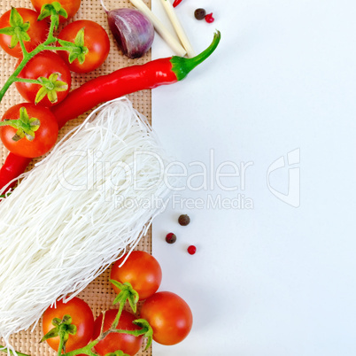 Frame of funchoza and tomatoes with paper on sacking