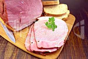 Ham smoked with bread on dark board