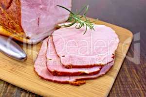 Ham smoked with rosemary on dark board
