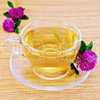 Herbal tea with clover on bamboo napkin