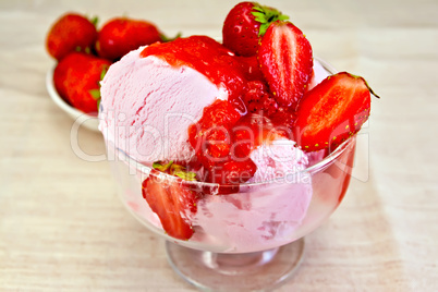 Ice cream strawberry in glass bowl with berries on fabric