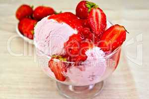 Ice cream strawberry in glass bowl with berries on fabric