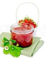 Jam strawberry with basket of berry on napkin