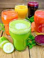 Juice cucumber and vegetable in glassful on board