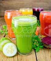 Juice cucumber and vegetable in glassful with parsley on board