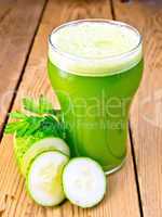 Juice cucumber in tall glassful on board
