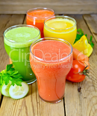 Juice tomato and vegetable in glassful on board