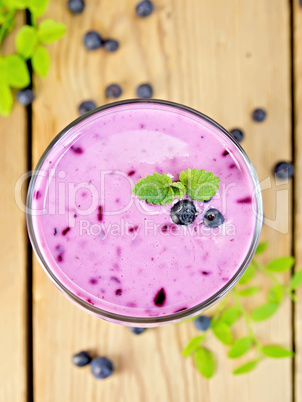 Milkshake with blueberries on board top