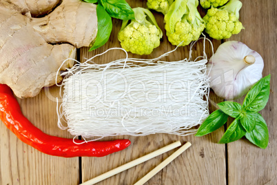 Noodles rice thin with broccoli and spices on board