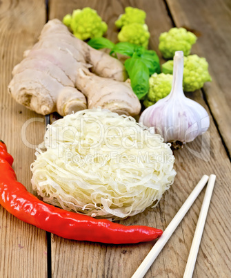 Noodles rice twisted with spices and broccoli on board