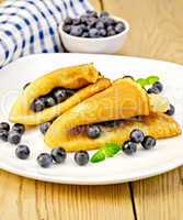 Pancakes with blueberries on board