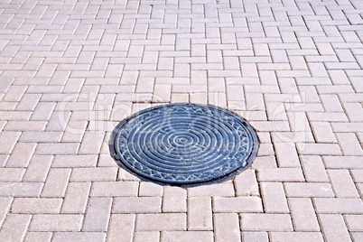 Pavement of tiles with a hatch