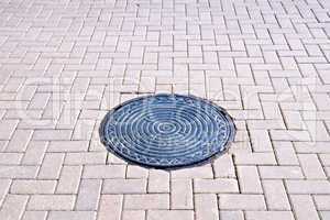 Pavement of tiles with a hatch