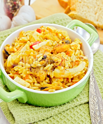 Pilaf with seafood and bread on napkin