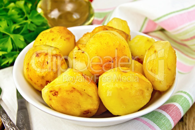 Potatoes fried in plate with oil on light board