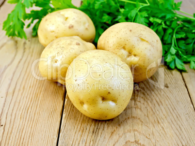 Potatoes yellow with parsley on wooden board