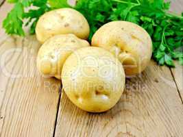 Potatoes yellow with parsley on wooden board