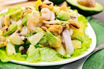 Salad seafood and avocado on green napkin