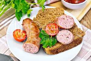 Sausages fried with bread and tomato in plate