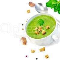 Soup puree with croutons and spoon in bowl