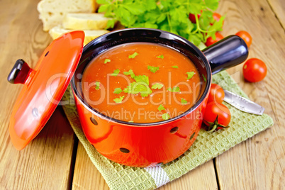 Soup tomato in red ware on board