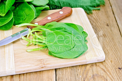 Spinach with knife on board