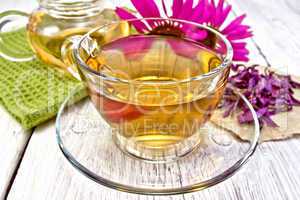 Tea Echinacea in glass cup on board with napkin
