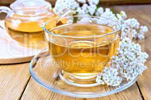 Tea with yarrow in cup on board