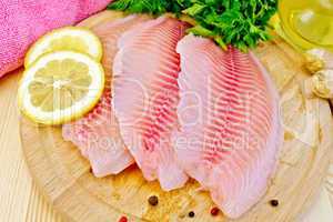 Tilapia with parsley and lemon on board
