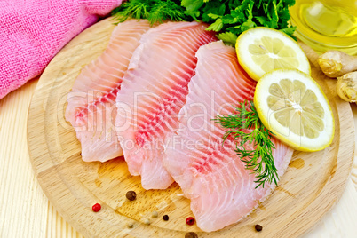 Tilapia with oil and lemon on light board