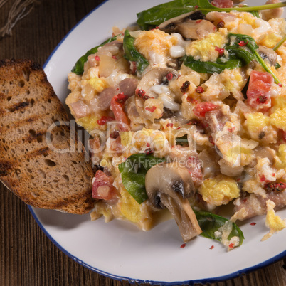 Scrambled eggs with tomatoes and spinach