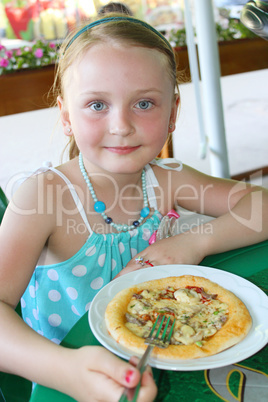 girl eating pizza