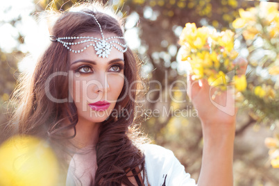 Woman Wearing Head Band Examining Tree Blossoms