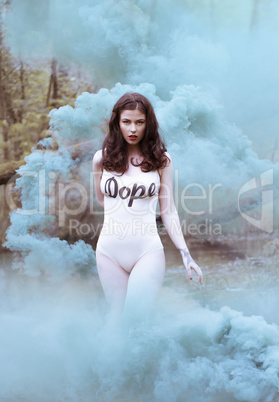 Woman Wearing Body Suit Walking Through Blue Smoke