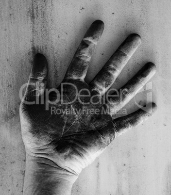 Left hand of a man dirty of charcoal