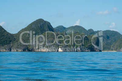 Scenic View of Rocky Coastline and Lush Mountains