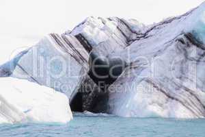 Heart seen in an Iceberg Floating in Jokulsarlon Under Overcast Sky