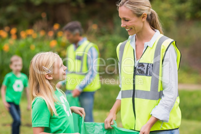 Happy family collecting rubbish