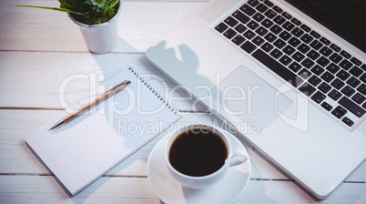 Overhead shot of laptop and notepad