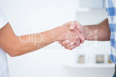 Patient shaking hands with doctor