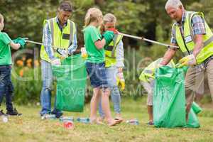 Happy family collecting rubbish