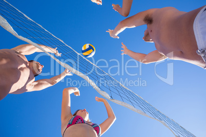 Group of friends playing volleyball