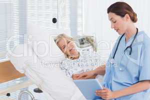 Doctor showing tablet to her patient