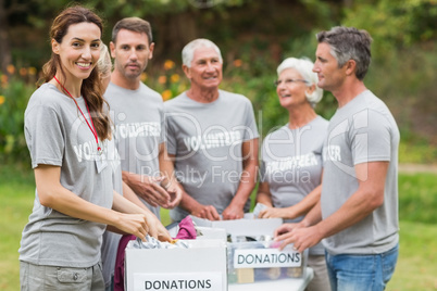 Happy volunteer family holding donation boxes