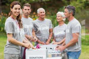 Happy volunteer family holding donation boxes